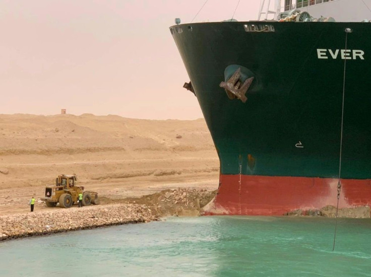 A handout picture released by the Suez Canal Authority on Wednesday shows a part of the MV Ever Given lodged sideways and blocking traffic on Egypt's Suez Canal