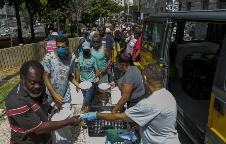 Homeless people receive lunch in downtown in Sao Paulo, Brazil, on March 23, 2021 amid an increase in poverty due to the pandemic