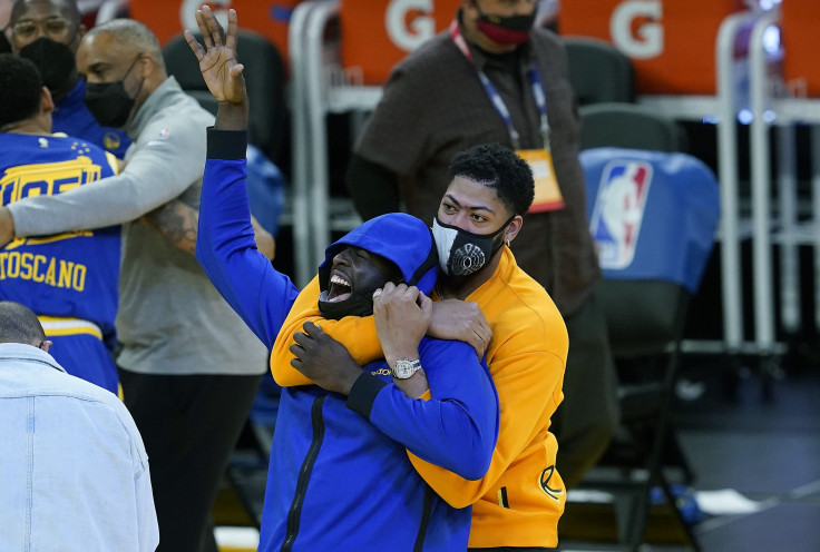  Injured player Anthony Davis #3 of the Los Angeles Lakers is seen playing around with Draymond Green #23 of the Golden State Warriors