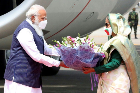 Prime Minister Sheikh Hasina (right) greets Indian Prime Minister Narendra Modi ahead of Independence Day celebrations