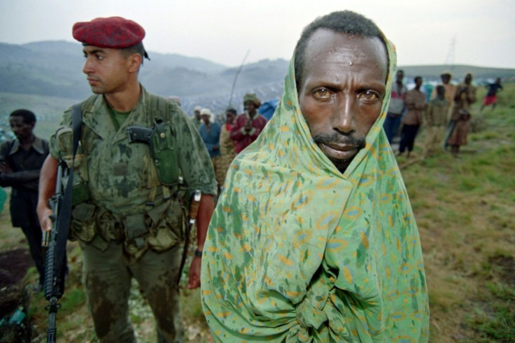 A Tutsi refugee waits in the rain in 1994 at the Nyarushishi refugee camp, where thousands of Tutsis lived under the protection of French forces