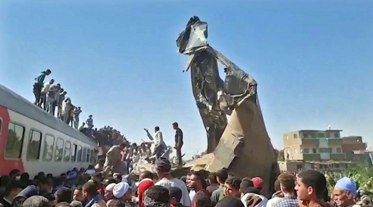 Twisted metal juts out from the wreckage of a train collision that killed at least 32 people and injured 91 in southern Egypt