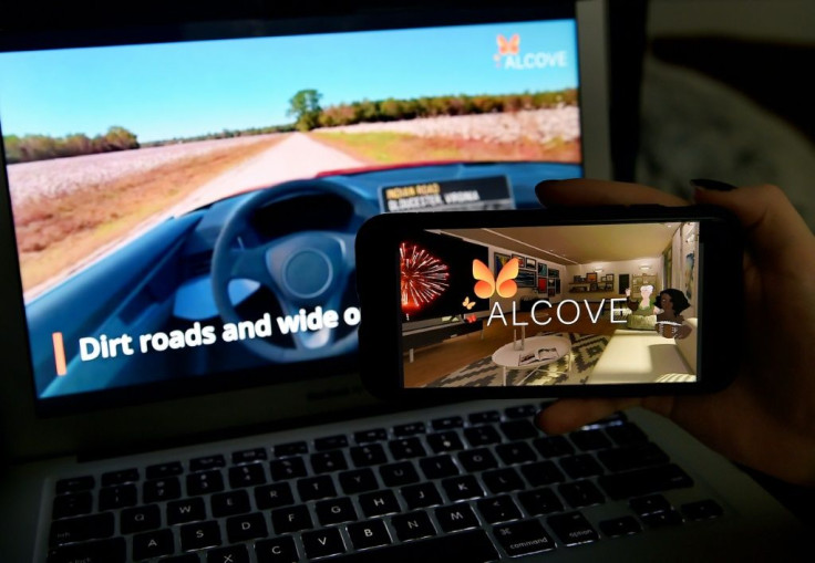 This illustration picture shows a virtual road trip on a computer and the travel application logo from Alcove, a platform for virtual reality travel which has gained momentum during the pandemic