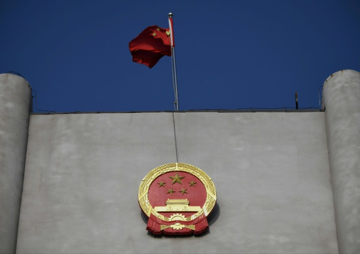 China's national flag flies at a court where a Canadian national's trial has opened on espionage charges