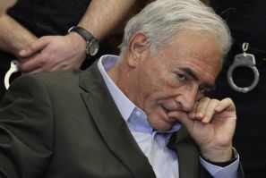 Former IMF chief Dominique Strauss-Kahn listens to his lawyer, William Taylor, inside of a New York State Supreme Courthouse during a bail hearing in New York May 19, 2011. Kahn was granted bail by a New York judge on Thursday, and the former IMF chief ha