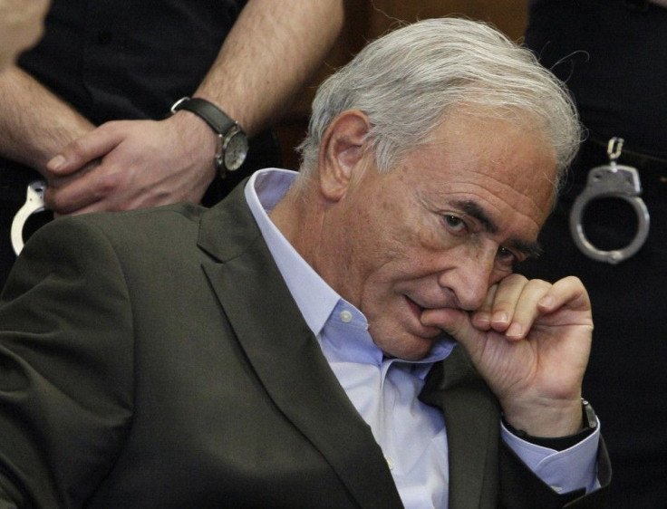 Former IMF chief Dominique Strauss-Kahn listens to his lawyer, William Taylor, inside of a New York State Supreme Courthouse during a bail hearing in New York May 19, 2011. Kahn was granted bail by a New York judge on Thursday, and the former IMF chief ha