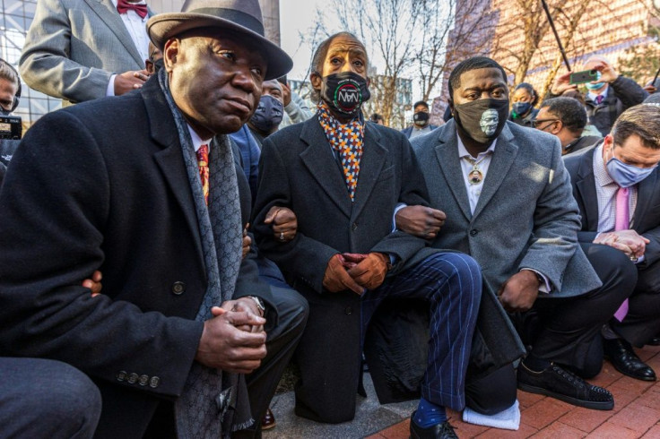 George Floyd supporters kneel in protest before the start of the trial of the police officer charged in his death