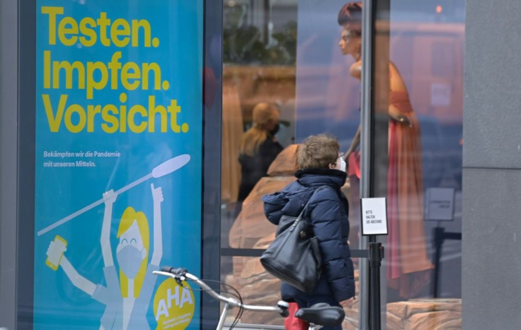 A poster in Germany urges: "Test. Vaccinate. Caution"