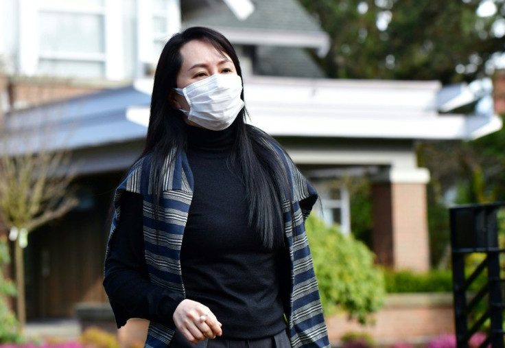 In this file photo taken on March 1, 2021 Huawei Chief Financial Officer, Meng Wanzhou, leaves her Vancouver home to attend British Columbia Supreme Court, in Vancouver, British Columbia. Huawei executive Meng Wanzhou was dealt another legal setback on Ma