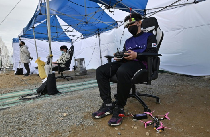 Drone pilots wear virtual-reality goggles that give them a drone's-eye view of the route