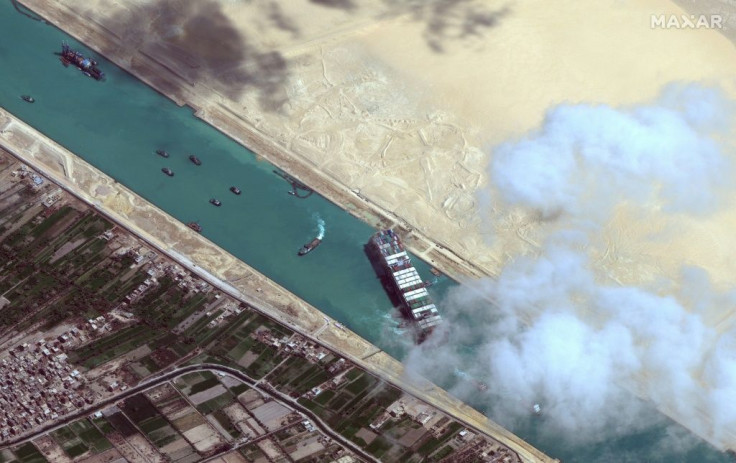 This satellite image released by Maxar Technologies shows the  MV Ever Given container ship and tugboats in the Suez Canal