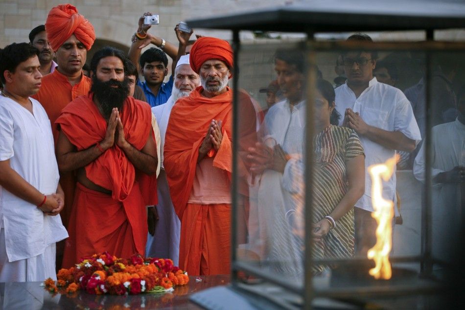 India039s yoga guru Swami Ramdev offers prayers at the Mahatma Gandhi memorial at Rajghat in New Delhi