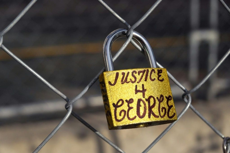 A lock attached to the fence surrounding the courthouse where former policeman Derek Chauvin is on trial