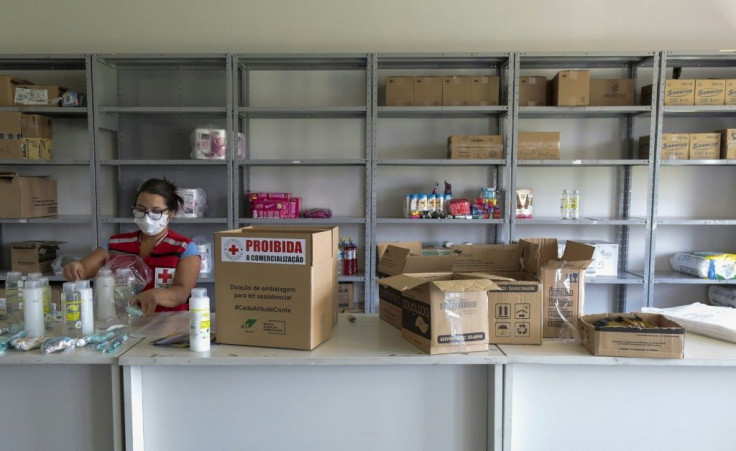 A volunteer from the Sao Paulo Red Cross prepares a kit with sanitation products to be donated to families affected by the Covid-19 pandemic in Sao Paulo, Brazil, on March 23, 2021