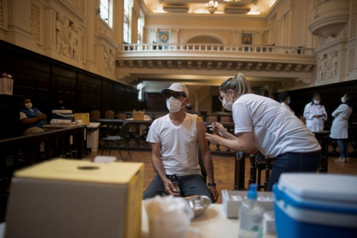 A man is inoculated against the coronavirus with a CoronaVac vaccine at the Justice Palace in Rio de Janeiro on March 31, 2021