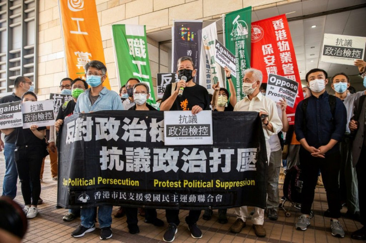 Pro-democracy activist Lee Cheuk-yan (C) speaks to the media next to former lawmaker Cyd Ho (centre L) outside West Kowloon Court in Hong Kong on April 1, 2021