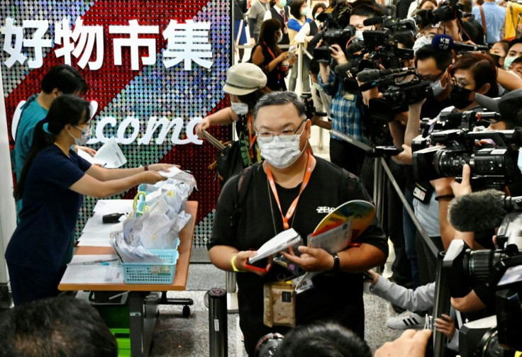 Taiwan tourists queue for Covid-19 tests before their flight to Palau. Taiwanese authorities said they all tested negative