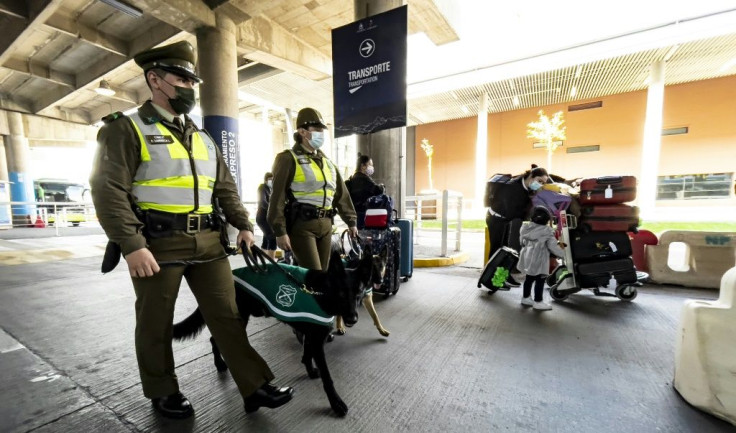 Police officers on patrol as passengers who just landed wait to be transfered to designated facilities to comply with a ten-day quarantine -- Chile closed its borders Monday amid a surge in COVID-19 cases