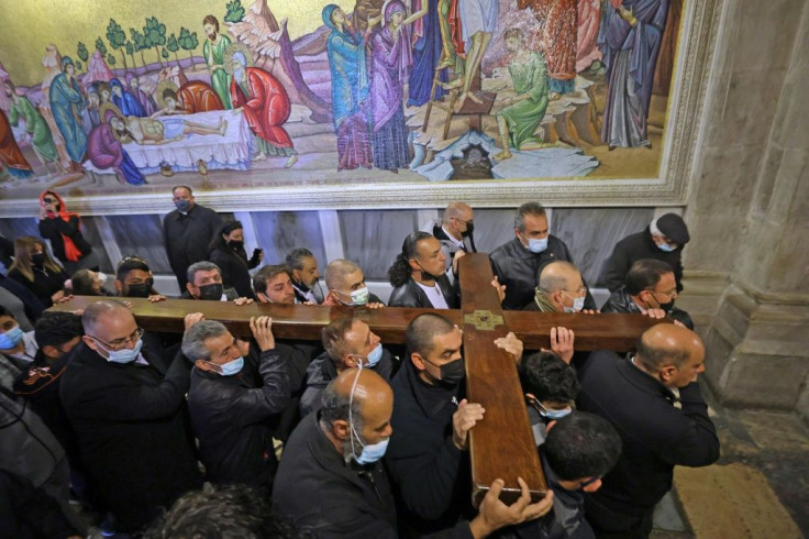 Hundreds of faithful, led by religious leaders bearing a cross, wound towards the church along the Via Dolorosa (Path of Sorrow) that snakes through the Old City.