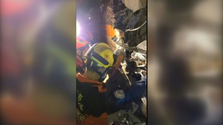 Emergency workers are seen working to try and free people trapped in the carriages of a train that crashed in eastern Taiwan. Dozens of people were killed in the incident when the packed train derailed. It's one of the island's worst railway accidents in