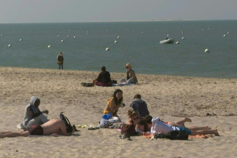 IMAGES People enjoy sunbathing and playing sports on the beach in Arcachon during Easter weekend, ahead of new travel restrictions to try to curb a dramatic rise in Covid-19 cases that has overwhelmed hospitals in the capital Paris.