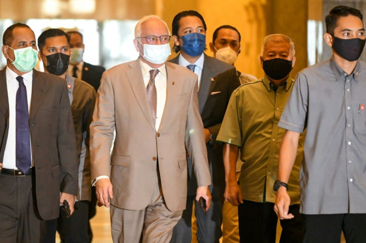 Malaysia's former prime minister Najib Razak (C) is appealing against his conviction on 1MDB-linked corruption charges