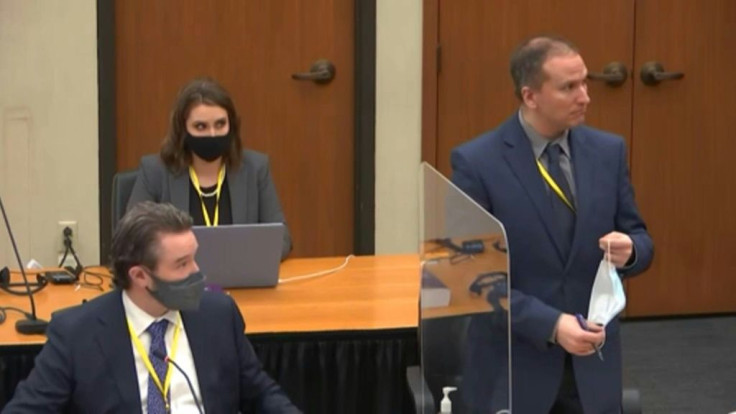 Derek Chauvin (R) removes his mask in this screenshot obtained from pool video feed via Court TV