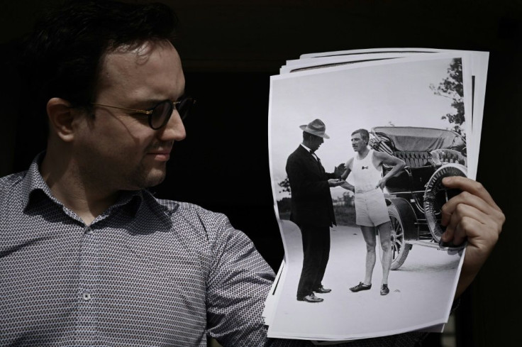 Clement Genty has been researching the story of Albert Corey and here holds up a photograph of the French marathon runner