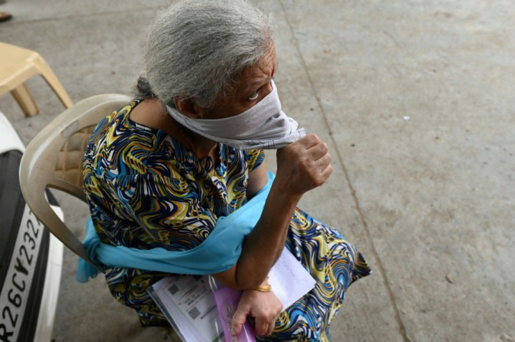 A woman waits for her turn to receive a Covaxin Covid-19 vaccine at a health centre in New Delhi