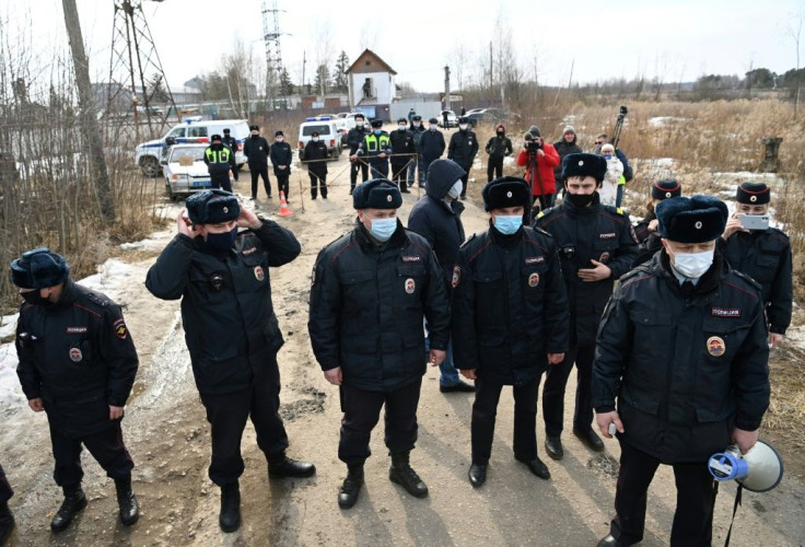Police officers guarding the entrance to the penal colony