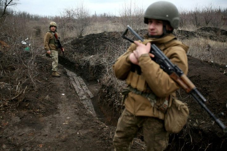 Ukrainian servicemen patrol along a position at the front line with Russia-backed separatists near Avdiivka, Donetsk region.