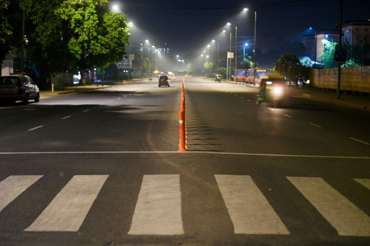 Streets were largely empty in New Delhi once the curfew went into effect, but some areas had regular night-time traffic