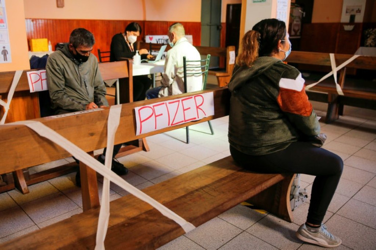 People wait for their turn to be vaccinated with the Pfizer vaccine against Covid-19, at the Medalla Milagrosa Church in Valparaiso, Chile, on April 6, 2021