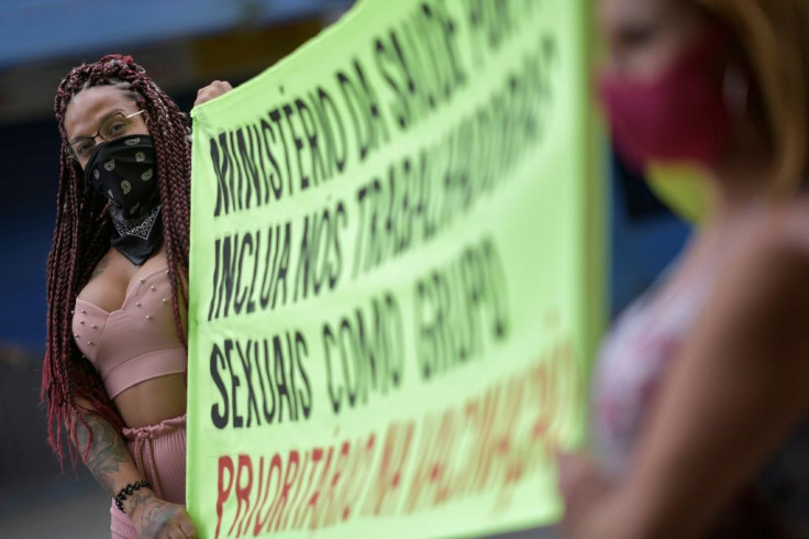 Sex workers protest at Rua Guaicurus, in Belo Horizonte, in Brazil's Minas Gerais state on April 5, 2021, asking to be considered a priority group to receive the vaccine against Covid-19