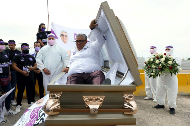Mexican congressional candidate Carlos Mayorga launches his campaign from inside a coffin to send a message to politicians that people are dying 'because of their indifference'