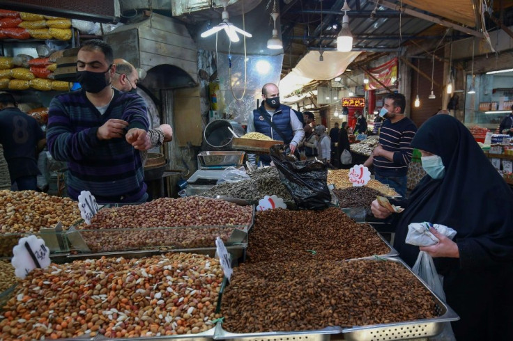 People shop in Jordan's capital Amman on April 5; ordinary Jordanians say a reporting blackout on matters of the royal family mean they hear little news on the matter