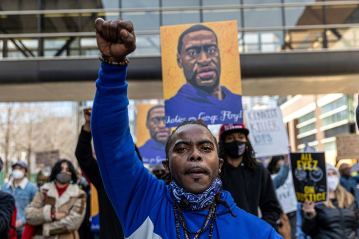 Demonstrators hold signs honouring George Floyd outside Hennepin County Court in Minneapolis, Minnesota