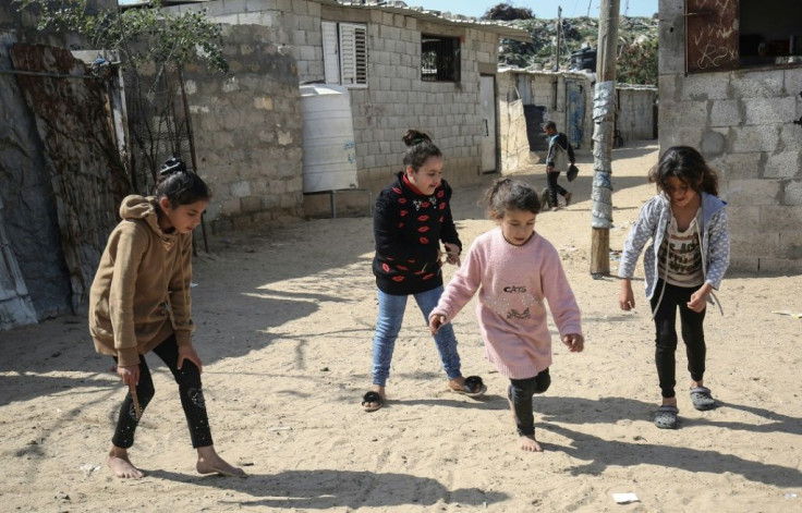 Palestinian girls gather in a street in the Khan Yunis camp for Palestinian refugees in the southern Gaza Strip in February 2021