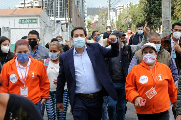 Ecuadoran presidential candidate Andres Arauz (C) greets supporters in Quito on April 6, 2021