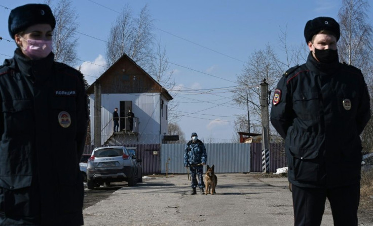 Russian police officers guard the entrance to the penal colony where Kremlin critic Alexei Navalny is being held