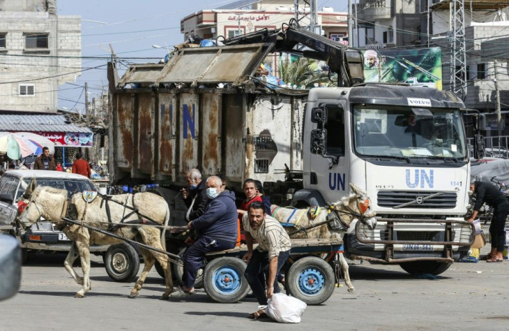 UNRWA workers clean a street at Rafah refugee camp in the Gaza Strip