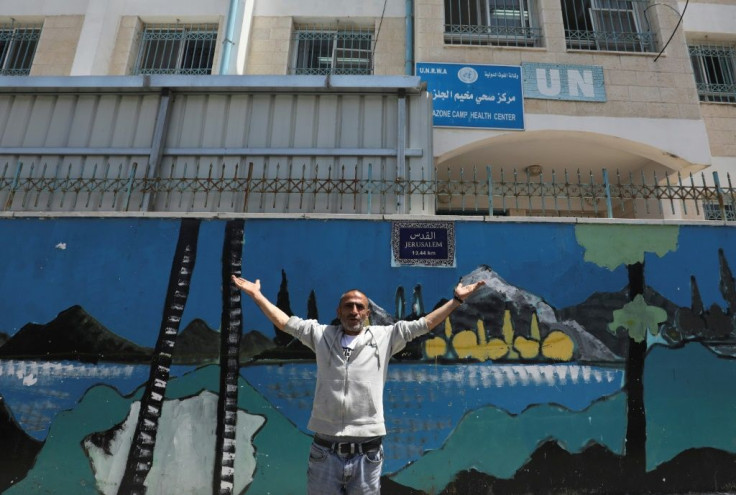 A Palestinian gestures outside a United Nations health centre in the Palestinian refugee camp of Al-Jalazoun near Ramallah on the West Bank