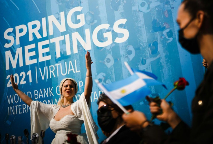 An activist dressed as Argentina's Evita Peron takes part in a rally calling for debt reform during the virtual Spring Meetings of the World Bank and International Monetary Fund
