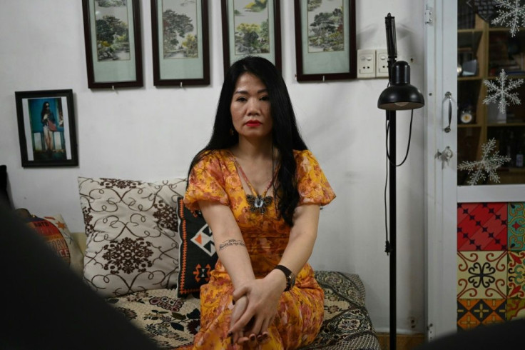 Nguyen Hong Thai chose a rose tattoo over a scar on her stomach, and the words "forever in my heart" on her arm, months after her husband died of lung cancer