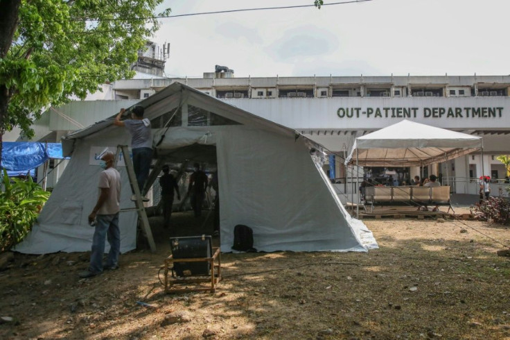 The government is distributing modular tents to struggling hospitals and re-deploying health workers from regions where virus transmission rates are low