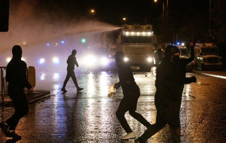 Hundreds of young men and boys gathered from early evening in a western Belfast neighbourhood