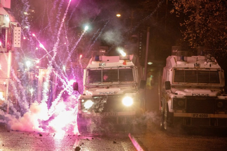Riot police formed ranks with armoured Land Rovers, as fireworks and petrol bombs were thrown at them