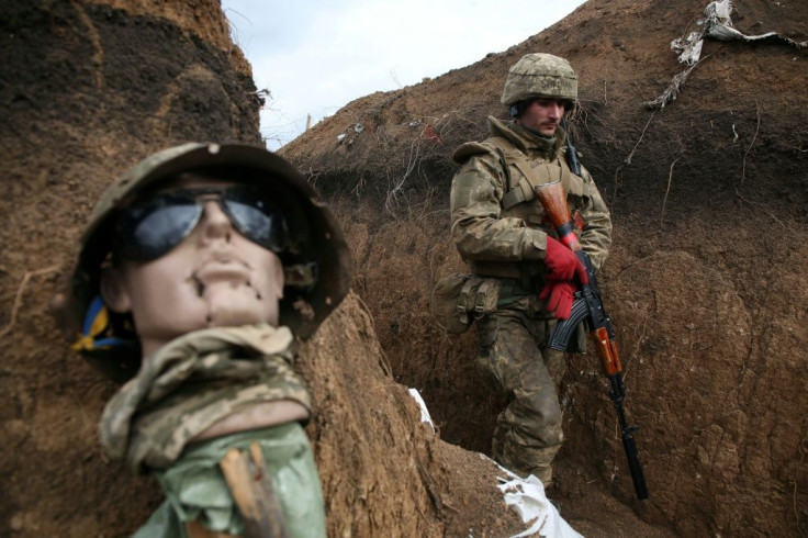 A dummy lies in the trenches of eastern Ukraine where 26 Ukrainian soldiers have died this year