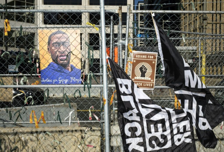 A portrait of George Floyd and banners on security fencing outside the Hennepin County Government Center where former police officer Derek Chauvin is on trial