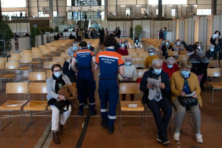 People wait in the observation room after receiving a dose of the Pfizer/BioNTech Covid-19 vaccine at a vaccination centre in Nantes, western France